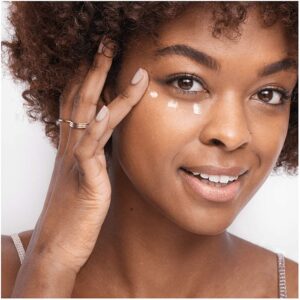 girl applying Olay Ultimate Eye Cream on face-min